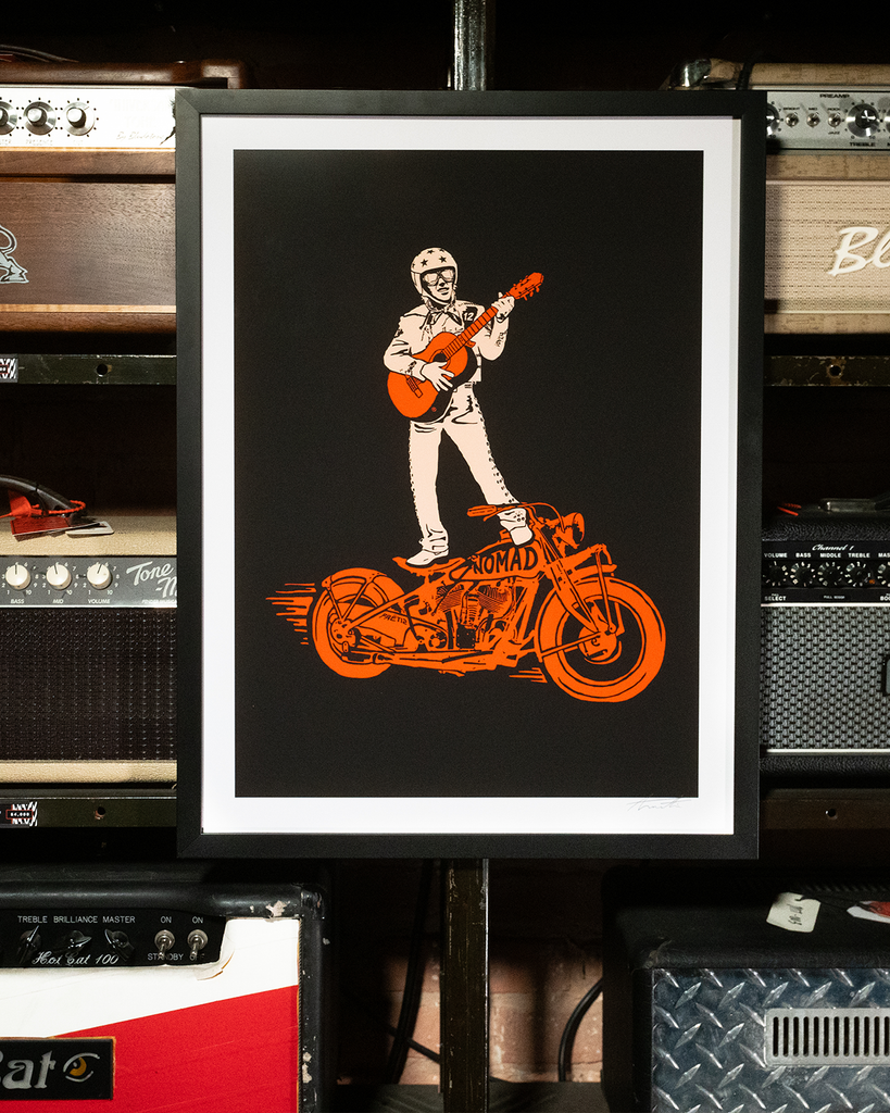 Giclée multicolor art print of the legendary Mariachi Rider, featuring the rider standing on a motorcycle while playing guitar. Printed on archival photo paper with vibrant details, hand-signed by artist Daniel Tremonti, and presented in a solid wood black gallery frame with a non-glare UV-resistant acrylic insert. Proudly made in the USA.