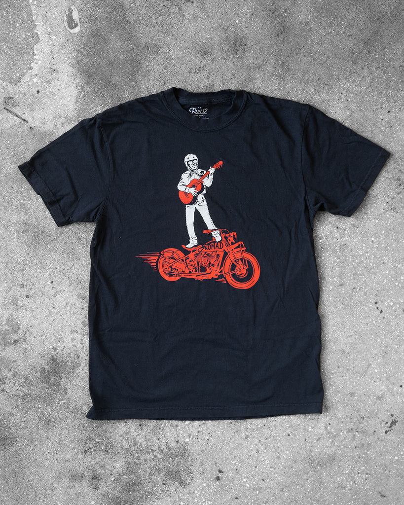 Black FRET12 Mariachi Rider Tee showcasing a bold graphic of the legendary Mariachi Rider standing on a motorcycle, strumming a guitar, set against a clean, minimal backdrop.